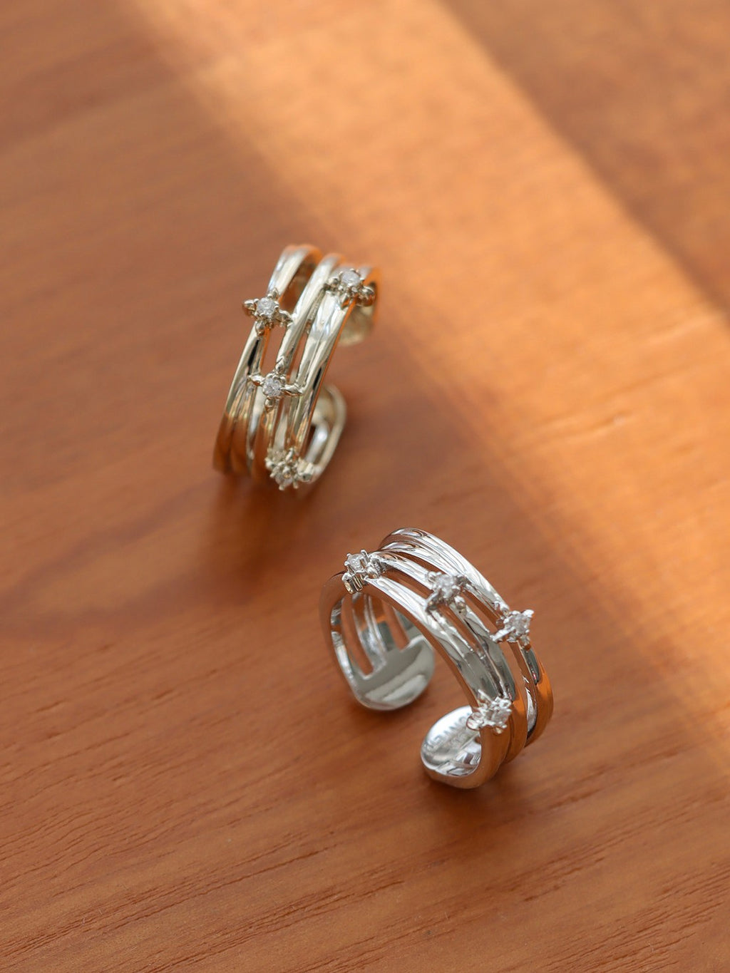 Dear Luma R005 silver multi layer iris ring product display on wood